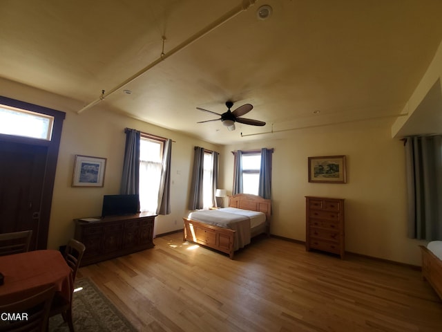 bedroom with light hardwood / wood-style floors and ceiling fan