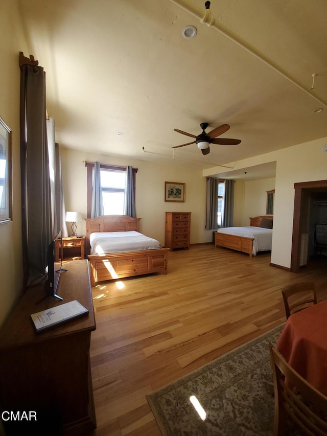 bedroom featuring light wood-type flooring and ceiling fan