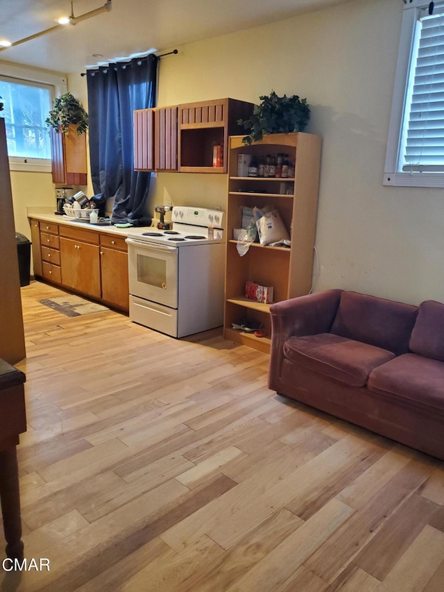 kitchen with light hardwood / wood-style floors and white range with electric cooktop