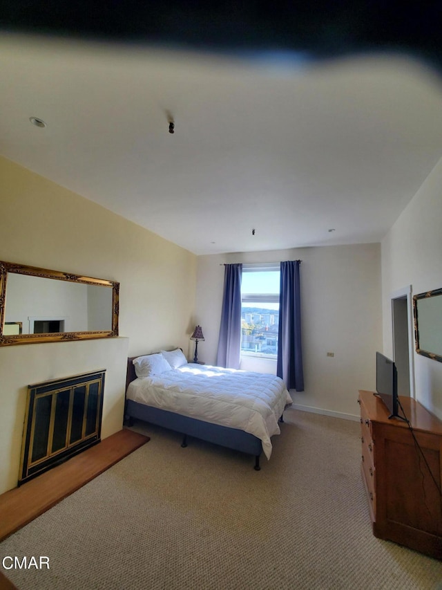 bedroom featuring light colored carpet