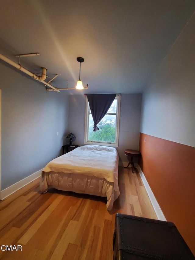 bedroom with ceiling fan and hardwood / wood-style floors