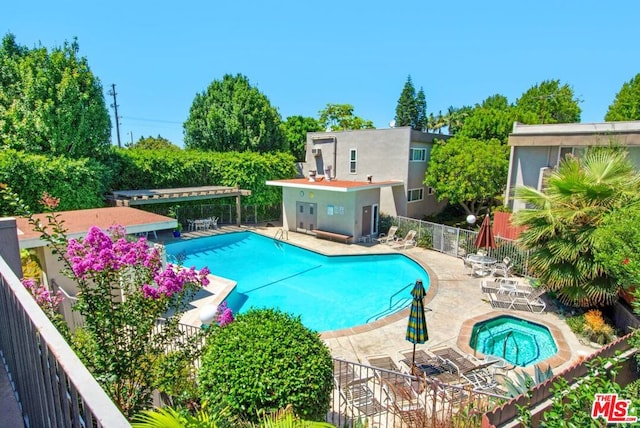 view of pool featuring a patio area and a hot tub