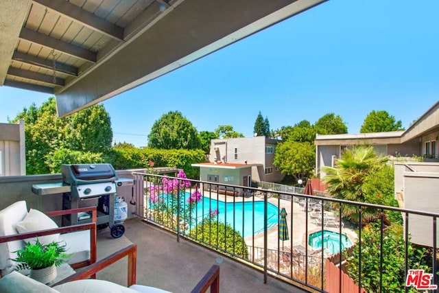 balcony featuring grilling area and an in ground hot tub