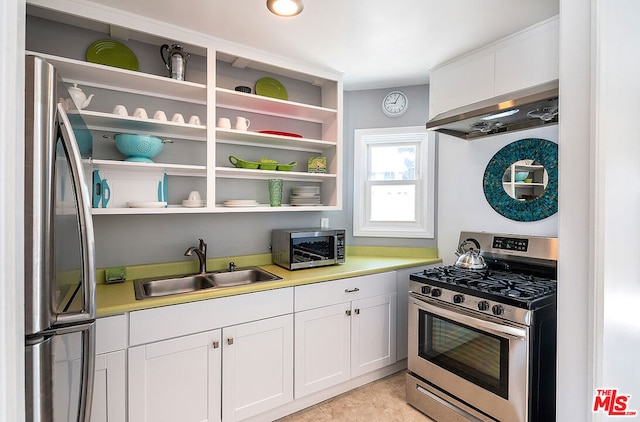 kitchen with stainless steel appliances, extractor fan, sink, light tile patterned floors, and white cabinetry