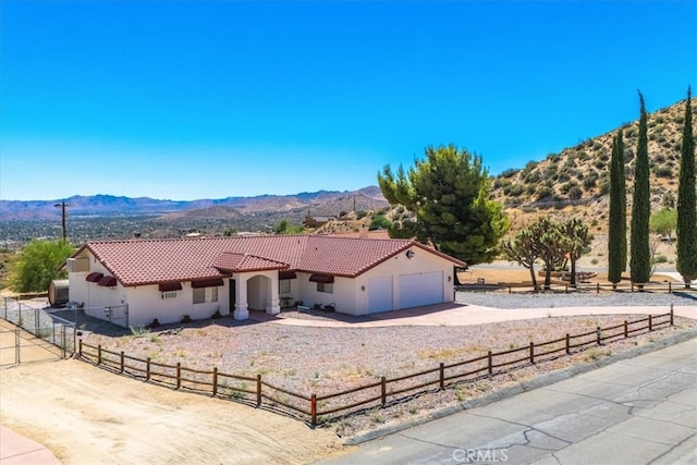 view of front facade with a mountain view and a garage