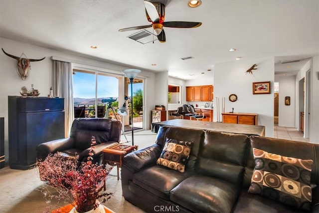 living room with ceiling fan and light colored carpet