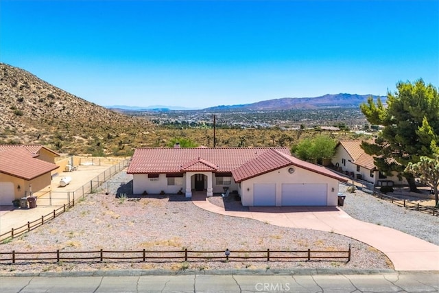 view of front of property featuring a garage and a mountain view