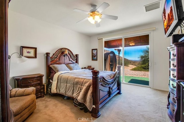 carpeted bedroom featuring ceiling fan and access to exterior