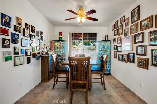 tiled dining area with ceiling fan