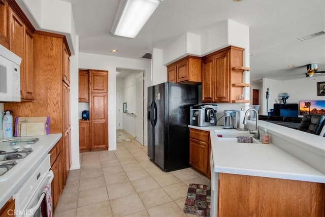 kitchen featuring ceiling fan, light tile patterned floors, sink, and white appliances