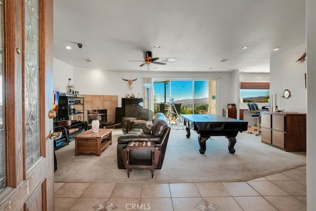 tiled living room with ceiling fan and billiards