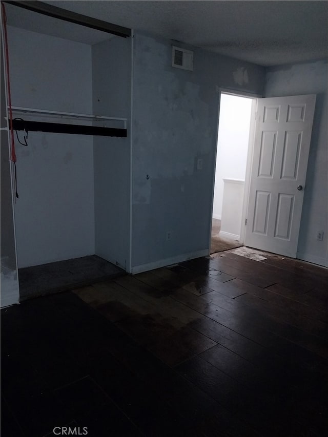 unfurnished bedroom with hardwood / wood-style flooring