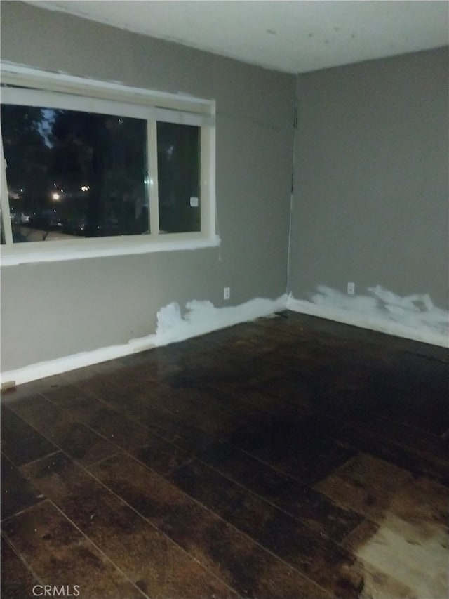 unfurnished room featuring dark hardwood / wood-style floors