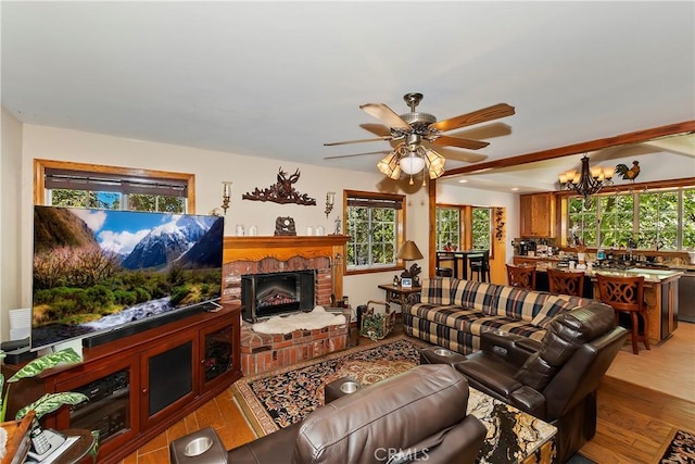 30184 Sky Line Dr, Running Springs, CA 92382 - living area with a ceiling fan, a fireplace, wood finished floors, and a chandelier
