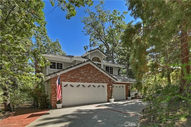 30184 Sky Line Dr, Running Springs, CA 92382 - traditional-style house with brick siding, driveway, and an attached garage