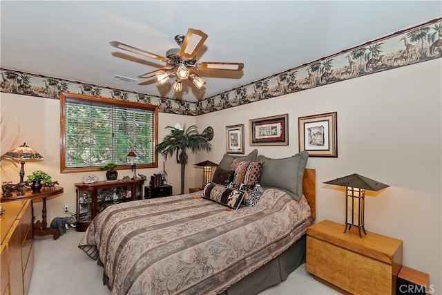 bedroom with ceiling fan and light colored carpet