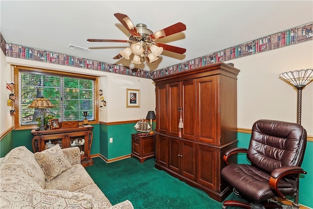 living area with dark carpet and ceiling fan