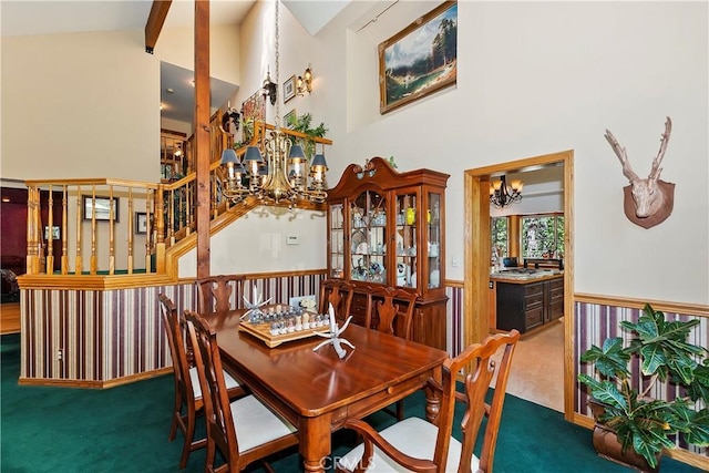 30184 Sky Line Dr, Running Springs, CA 92382 - carpeted dining space featuring a chandelier, high vaulted ceiling, beamed ceiling, and stairs