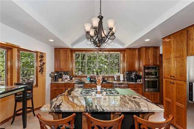 30184 Sky Line Dr, Running Springs, CA 92382 - kitchen with stainless steel appliances, a breakfast bar area, brown cabinetry, vaulted ceiling, and recessed lighting