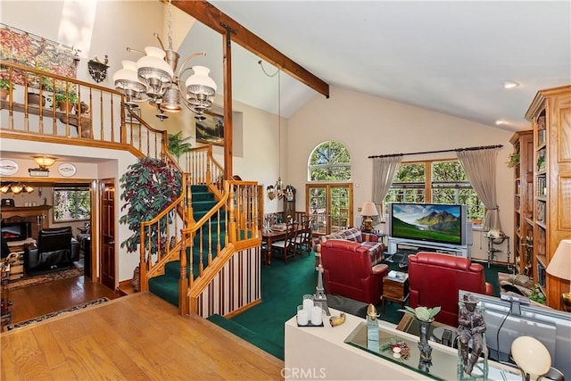 30184 Sky Line Dr, Running Springs, CA 92382 - living area featuring a chandelier, stairs, plenty of natural light, wood finished floors, and high vaulted ceiling