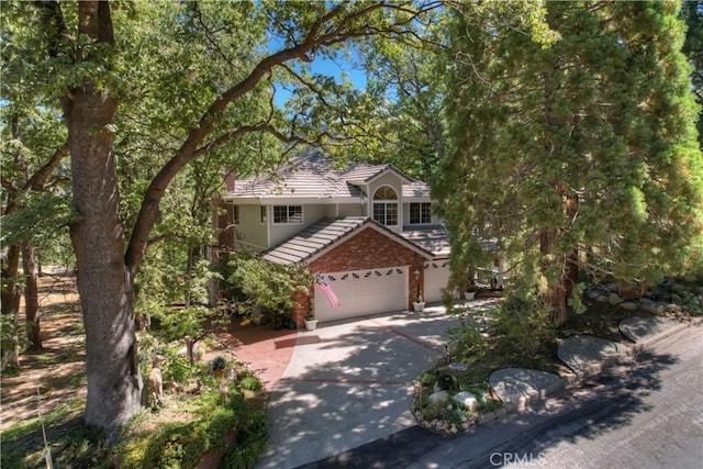 30184 Sky Line Dr, Running Springs, CA 92382 - view of front facade with a tile roof, concrete driveway, and an attached garage