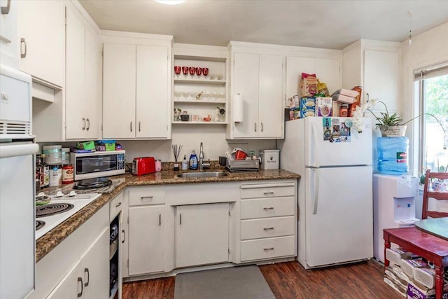 kitchen with dark wood-type flooring, white appliances, white cabinetry, and sink