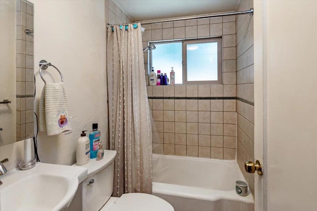 full bathroom with toilet, sink, and shower / tub combo