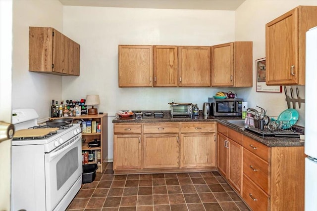 kitchen featuring white range with gas cooktop and sink