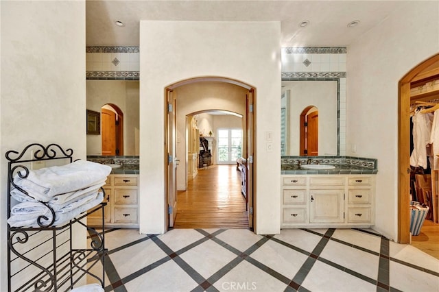 bathroom featuring backsplash, vanity, and hardwood / wood-style flooring