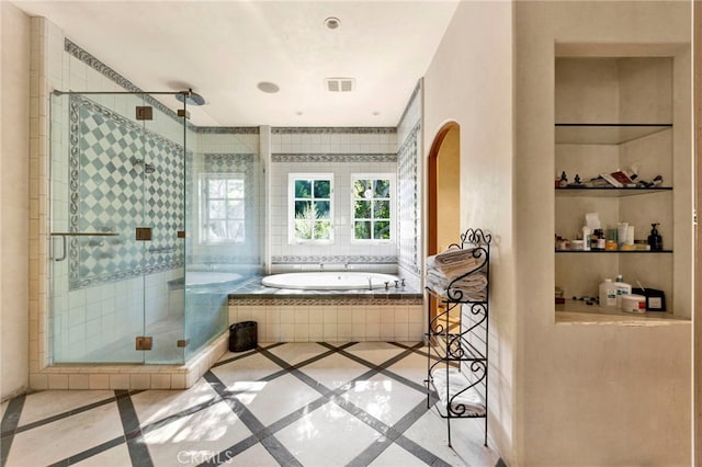 bathroom featuring separate shower and tub