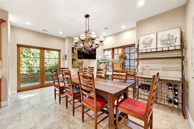 dining room featuring french doors and a notable chandelier