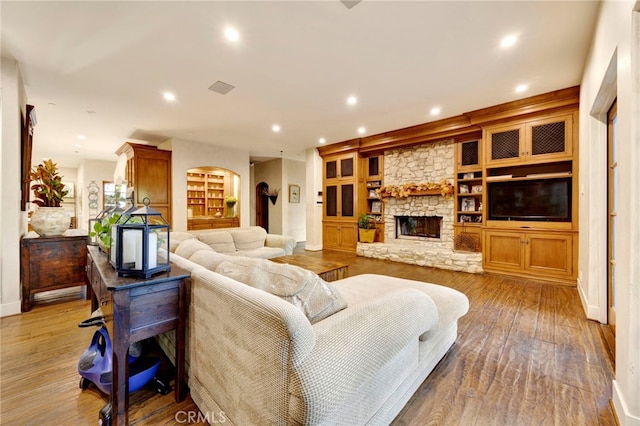 living room with light hardwood / wood-style floors and a fireplace