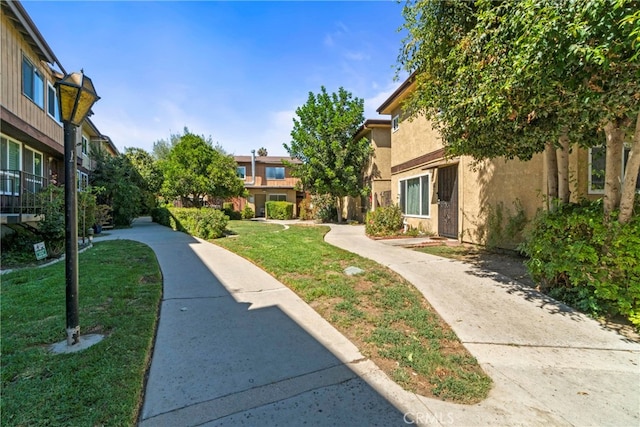 surrounding community with a residential view and a lawn