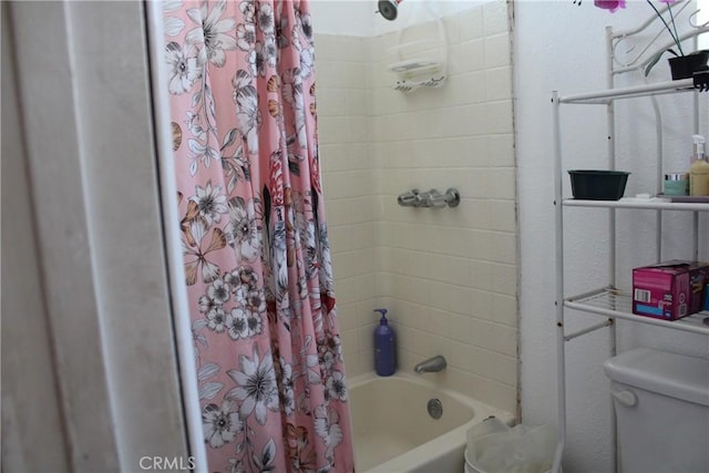 bathroom with toilet and shower / tub combo