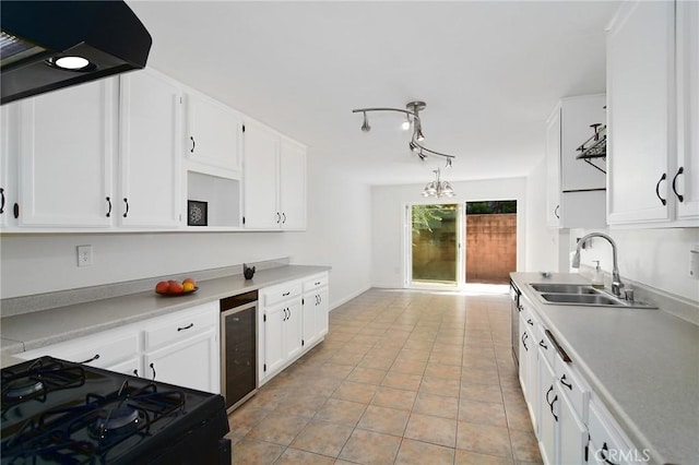 kitchen featuring black stove, wine cooler, and white cabinetry