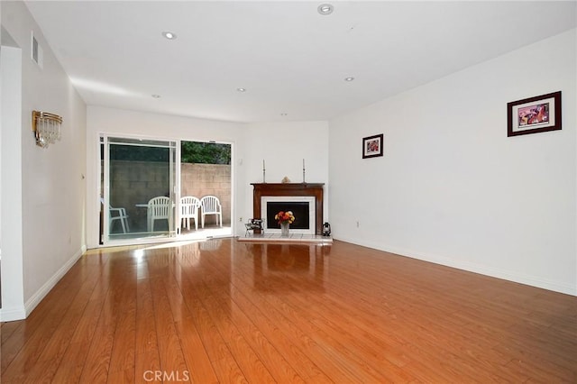 unfurnished living room with light hardwood / wood-style flooring