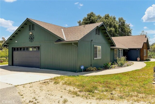 view of side of home featuring a garage