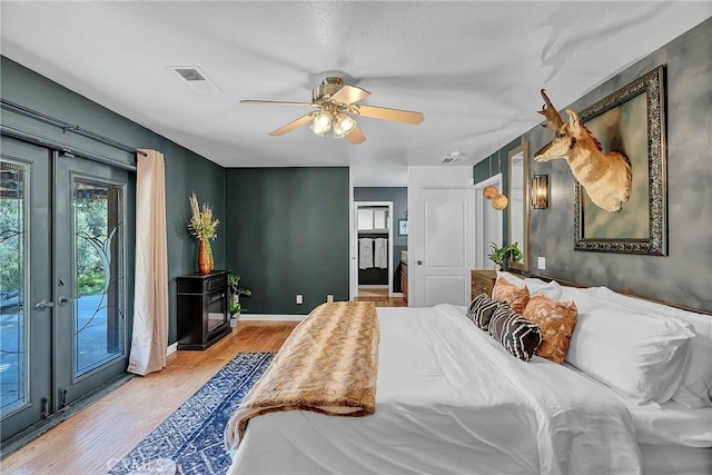 bedroom with ceiling fan, access to exterior, light hardwood / wood-style flooring, and french doors