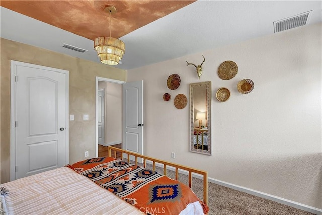 bedroom featuring a chandelier and carpet floors