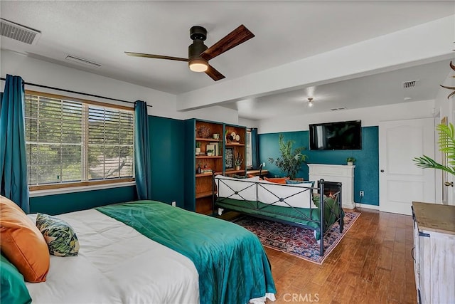 bedroom with ceiling fan and hardwood / wood-style flooring