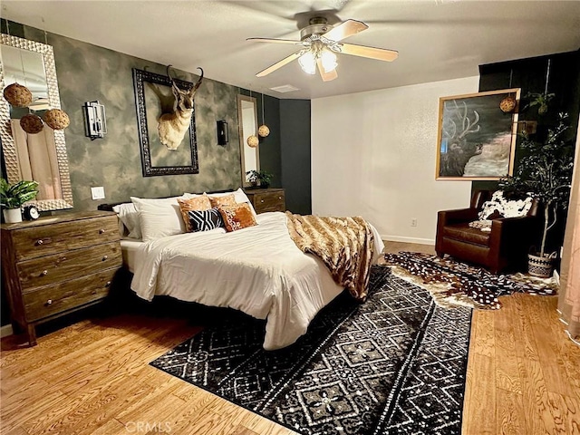 bedroom with ceiling fan and light hardwood / wood-style floors