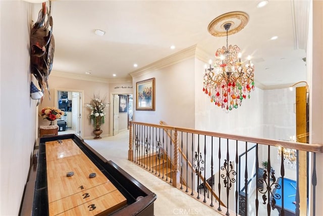 hallway with crown molding, carpet, and a notable chandelier