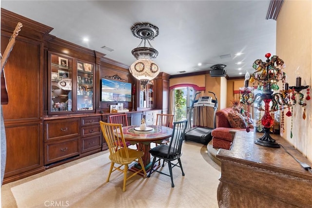 dining space featuring light carpet and ornamental molding