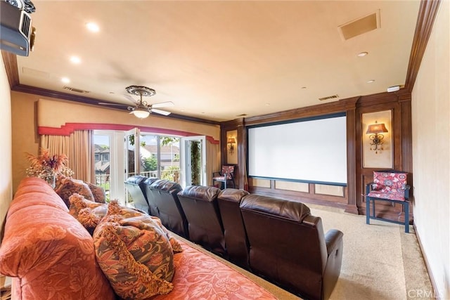 carpeted cinema with ceiling fan and crown molding