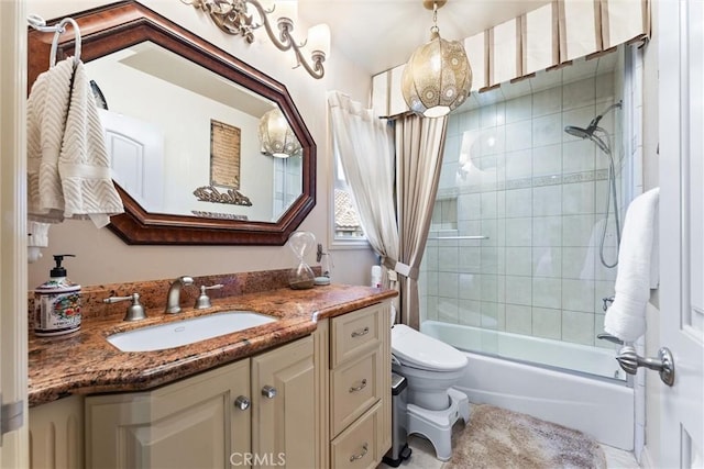 full bathroom featuring vanity, bath / shower combo with glass door, and toilet