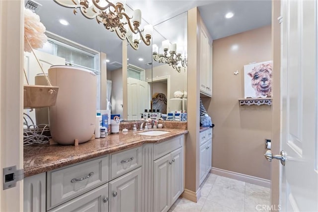 bathroom featuring a chandelier, vanity, and tile patterned flooring