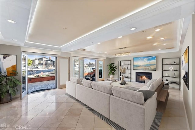 tiled living room featuring a tray ceiling