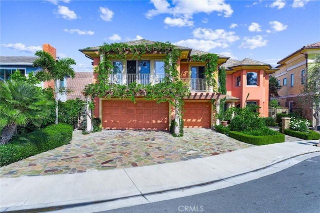 view of front of property with a balcony and a garage