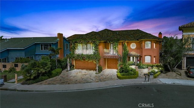 view of front of home with a balcony and a garage