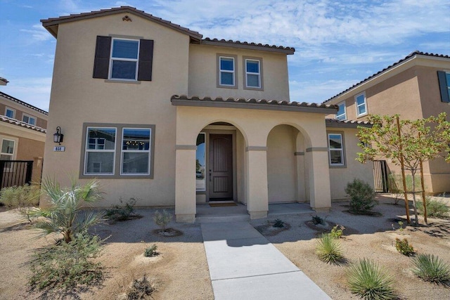 mediterranean / spanish-style home featuring a porch